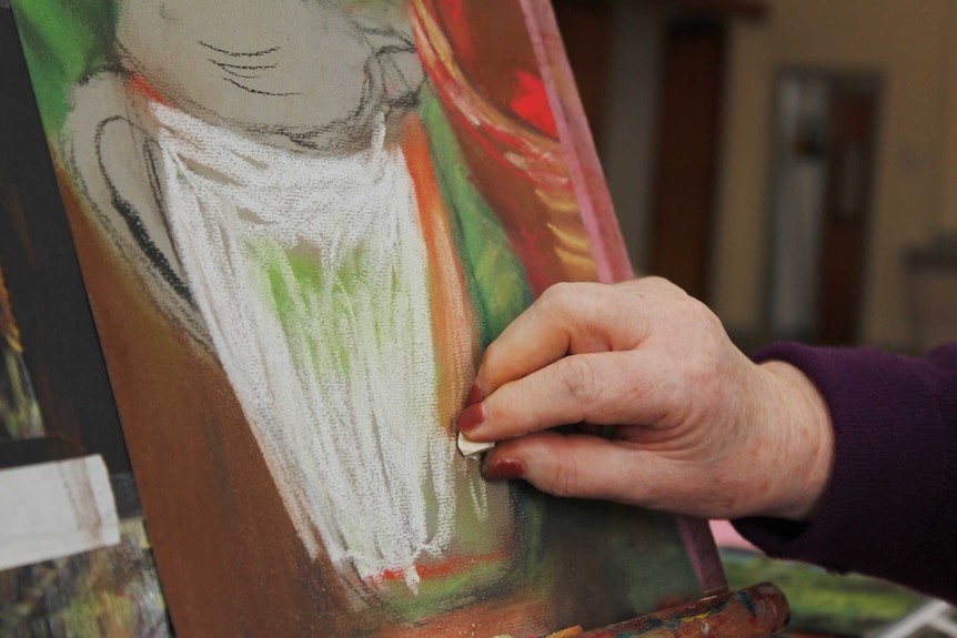 Jan Stone working on her artwork in Launceston