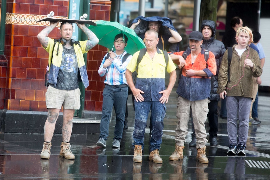 Pedestrians in the Melbourne CBD caught in the rain on Friday, 1 December, 2017.