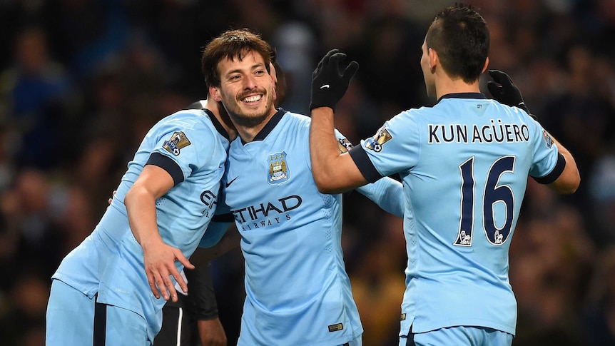 Manchester City's David Silva (C) celebrates with team-mates after scoring against Newcastle.