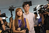 Newly elected Hong Kong lawmakers Yau Wai-ching and Sixtus 'Baggio' Leung surrounded by photographers.