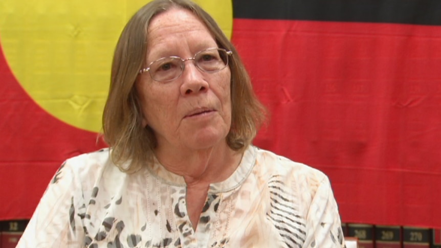 Heather Sculthorpe in front of aboriginal flag