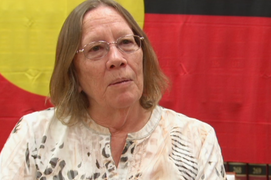 Heather Sculthorpe in front of aboriginal flag