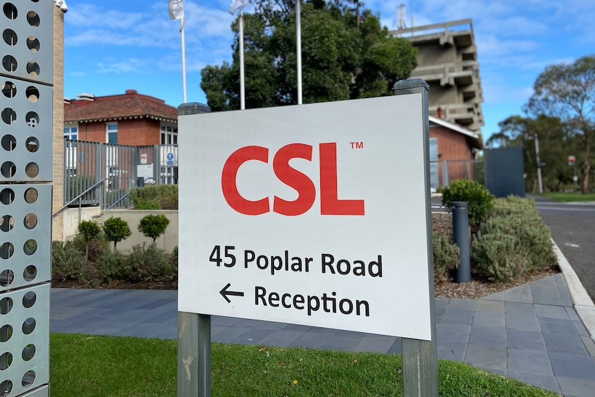 A white sign with a red CSL logo and an arrow pointing to reception.