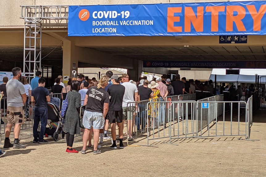 A queue of people entering a COVID vaccination hub at Boondall