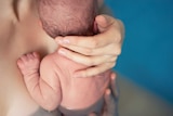 Newborn baby with birthing pool