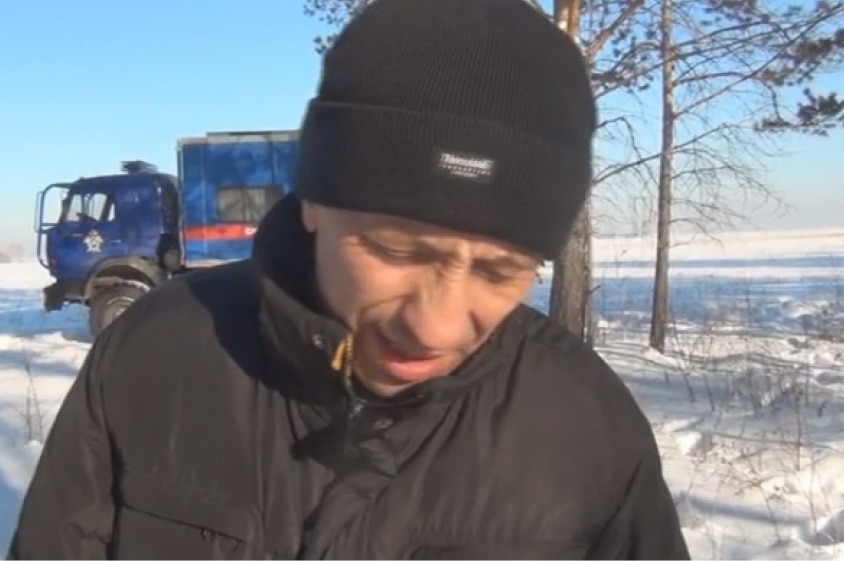 A man in warm clothes standing in the snow