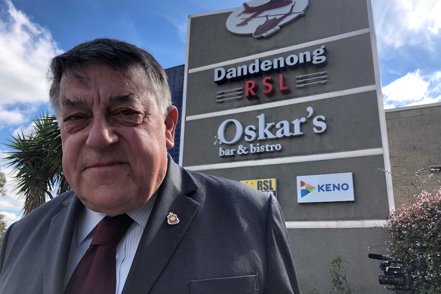 John Wells, President of the Dandenong RSL, standing in front of the RSL sign