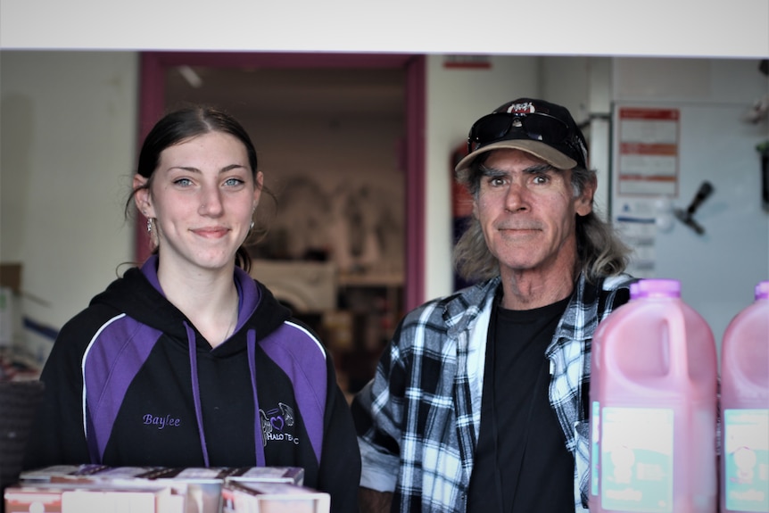 Baylee and Steve pictured in the window of the soup kitchen smiling