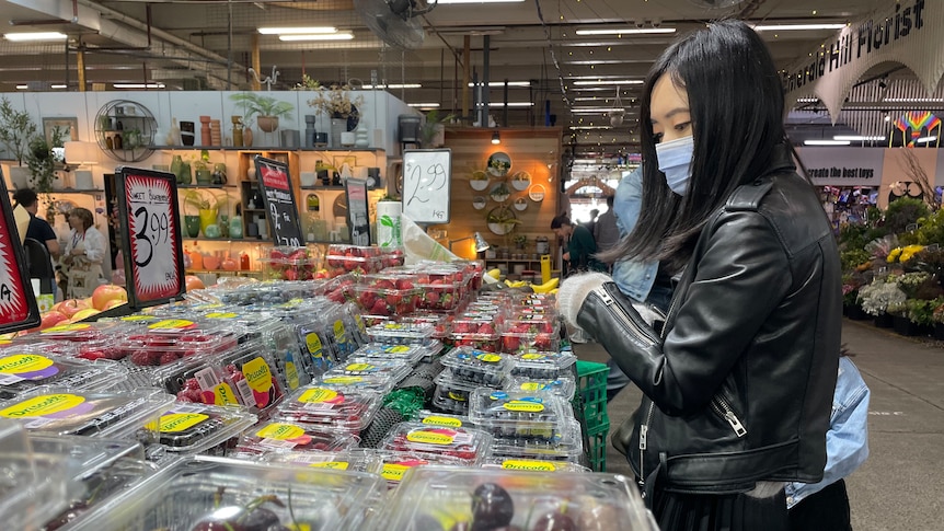 A person shopping at a market.