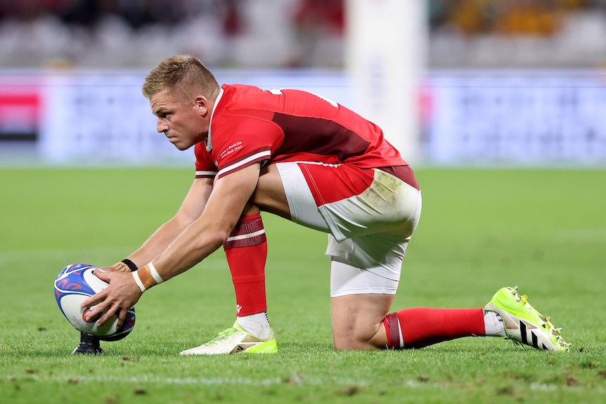 Gareth Anscombe places the ball