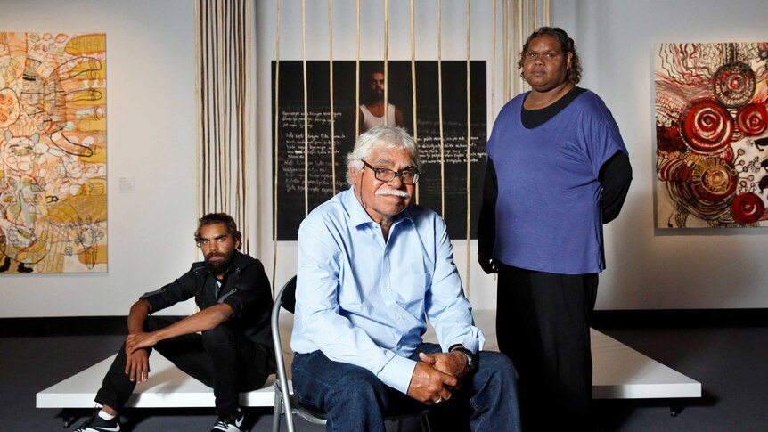 Artists Anwar Young Frank Young, and Unrupa Rhonda Dick stand in front of their artwork.