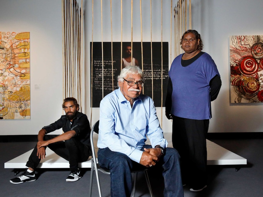 Artists Anwar Young Frank Young, and Unrupa Rhonda Dick stand in front of their artwork.