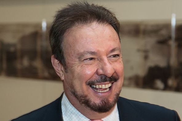 Former South Australian gallery director Ron Radford smiling at an art gallery