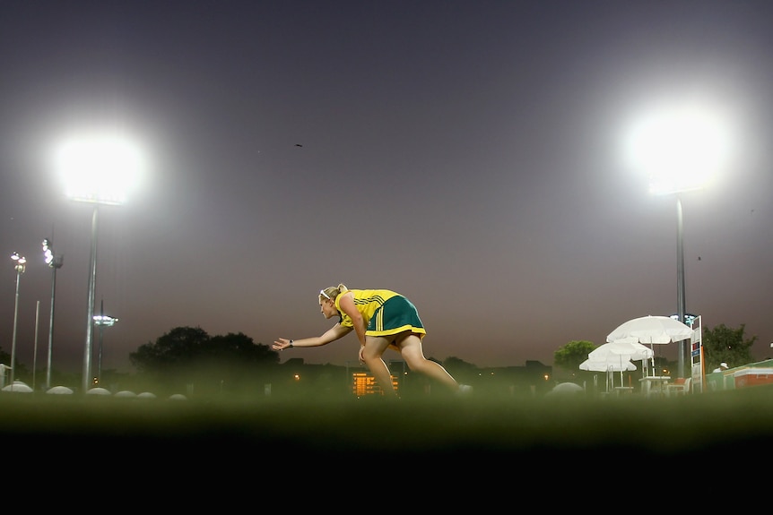 Natasha Van Eldik bowls while the sun sets.