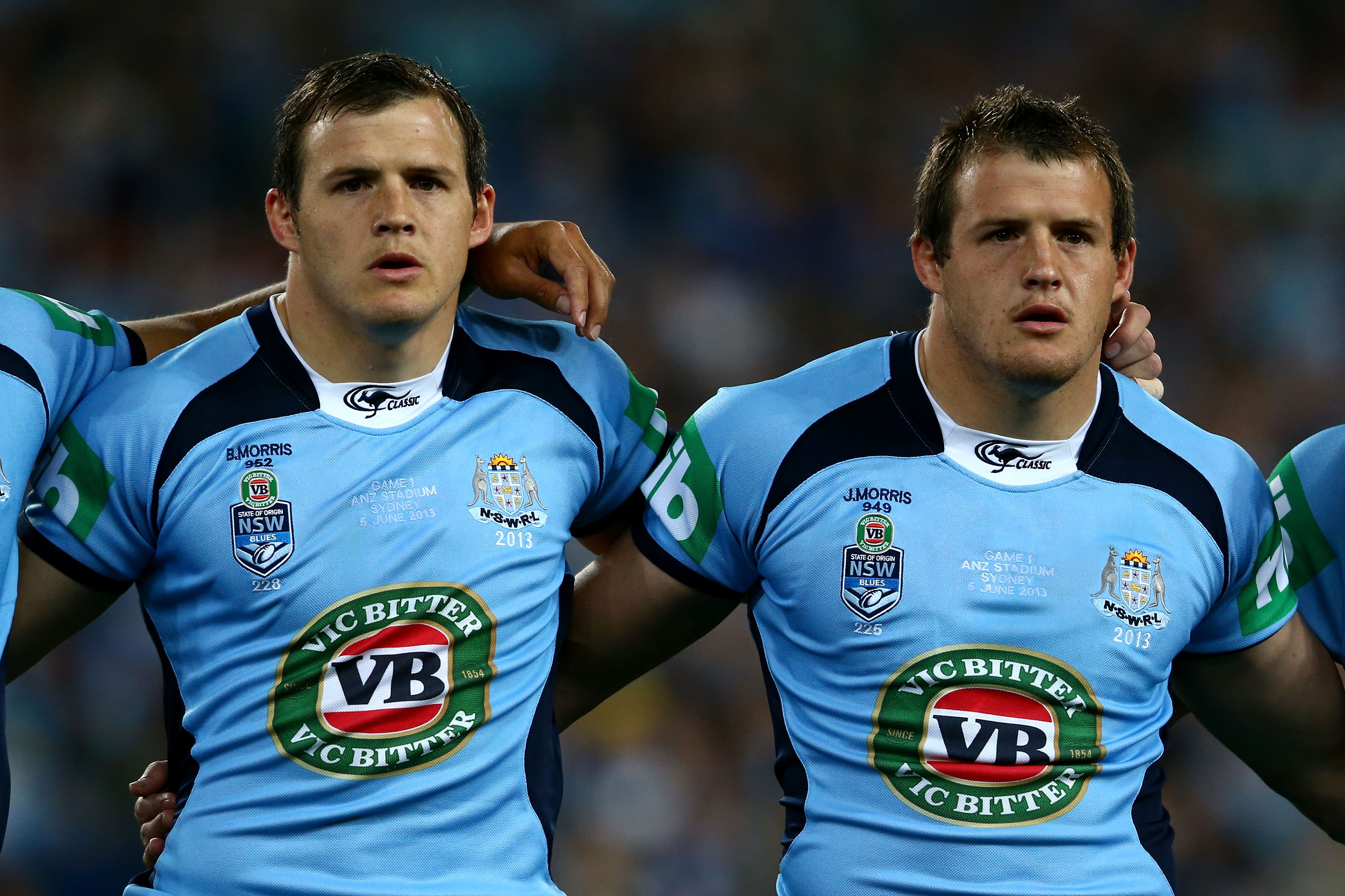 The Morris twins line up for the national anthem before an Origin match