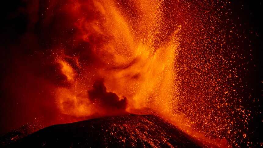Volcano erupts at night. 
