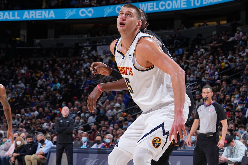 A Denver Nuggets NBA player watches the ball in the air during a game.