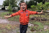 Four year old Freddie Griffin is loving the rain at Cloncurry. 