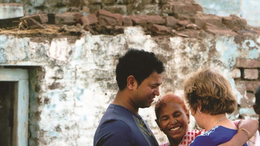 Saroo Brierly an indian orphan boy (now an adult) has his arm around his adoptive mother Sue from Australia and his birth mother