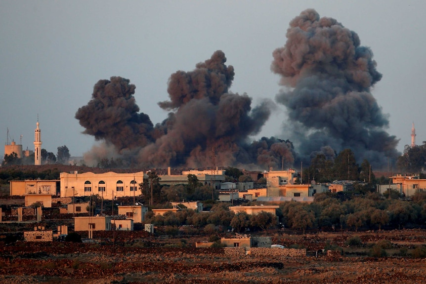 Smoke can be seen following an explosion at the Syrian side of the Israeli-Syrian border