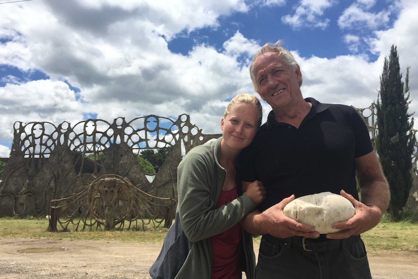 Tony Phantastes and daughter Anneka stand in front of his gothic-looking artwork Dreamers Gate in Collector.