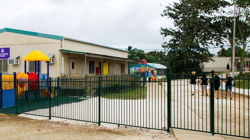 Teachers walk towards asylum seekers' classroom on Christmas Island