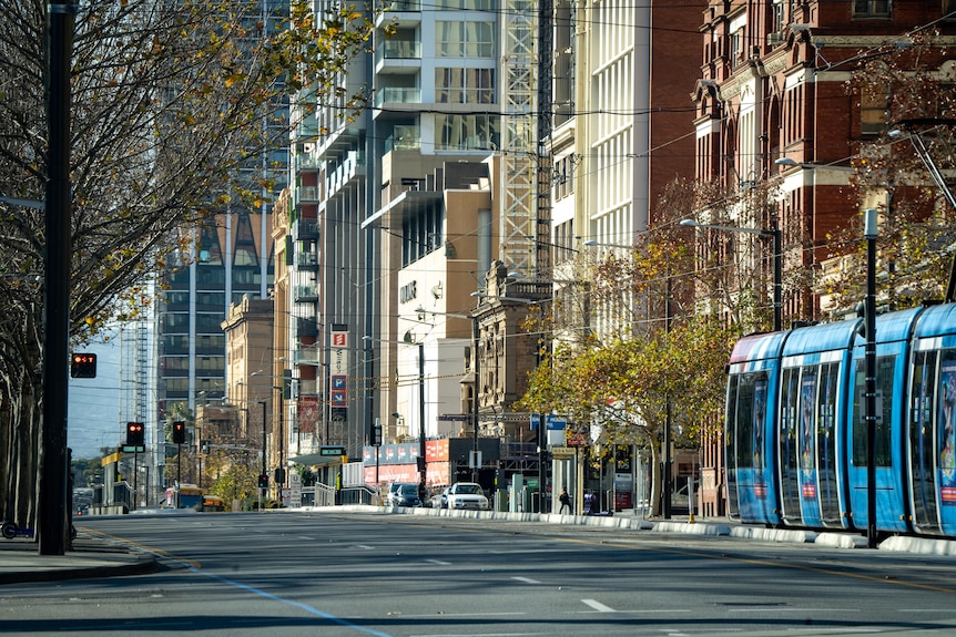 A wide street with a tram and old buildings