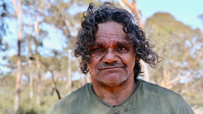 portrait of indigenous man with curly hair. 