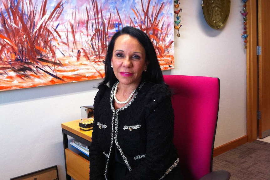 Linda Burney sits at a desk in her office.