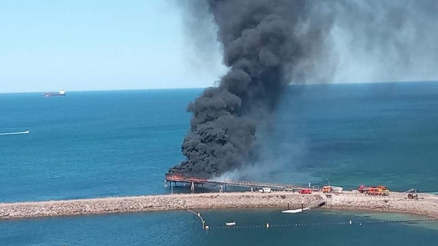 Black smoke rising above a jetty in Whyalla