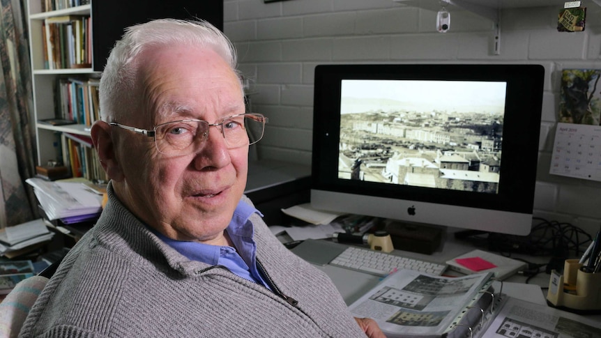 Colin Dennison sits at his computer