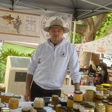 Dolfi at a market stall selling honey