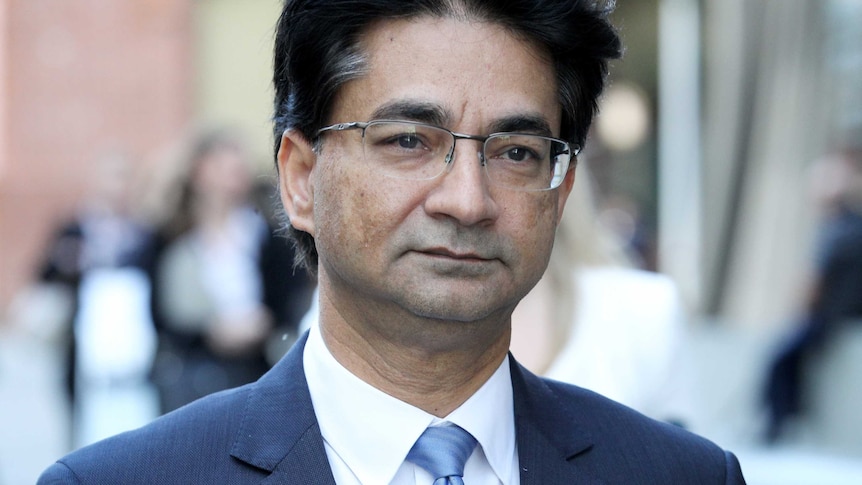 A tight head and shoulders shot of lloyd Rayney wearing a blue suit.
