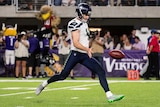 Michael Dickson, on the field for the Seahawks, prepares to kick the ball.