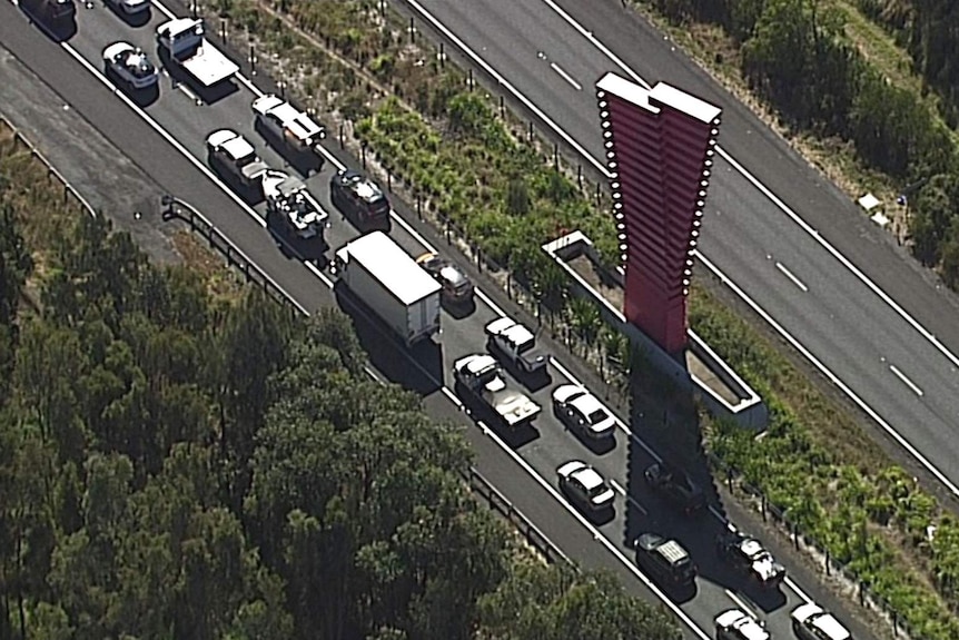 A line of cars on the Pacific Highway at the Queensland border crossing point, as seen from above
