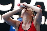 Simona Halep raises her hands to her face as she celebrates beating Angelique Kerber in their Australian Open semi-final.