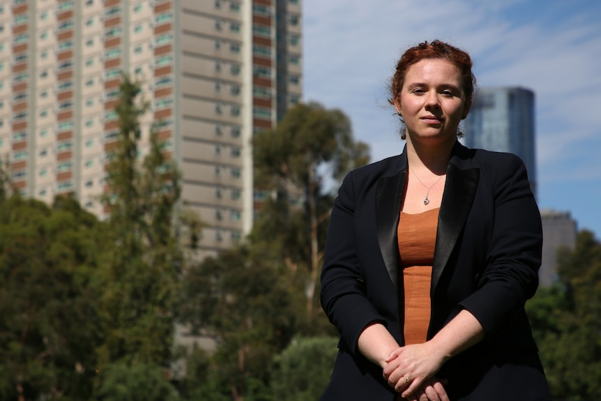 Katelyn standing in front of the Fitzroy Housing Commission Flats