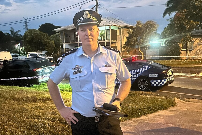 A senior police officer stands outside a house in Mackay.