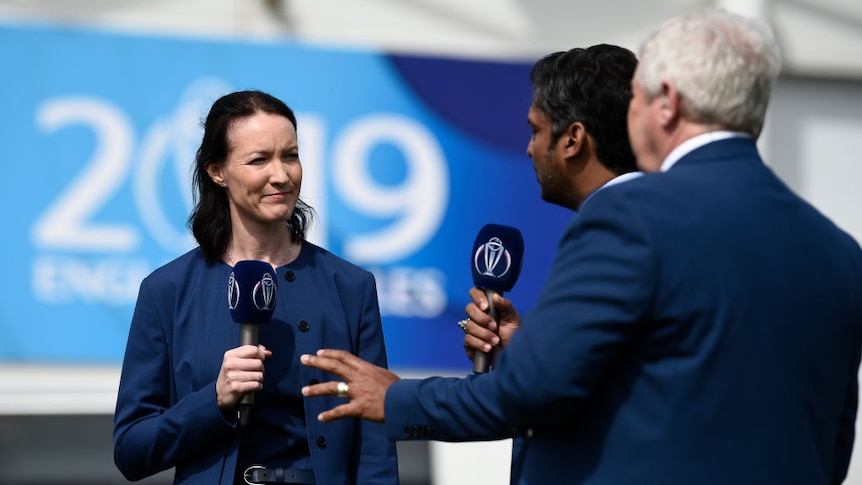 Commentator Alison Mitchell stands next to two male commentators at the Group Stage match of the ICC Cricket World Cup 2019.