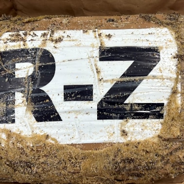 A dirty package with letters R-Z on it 