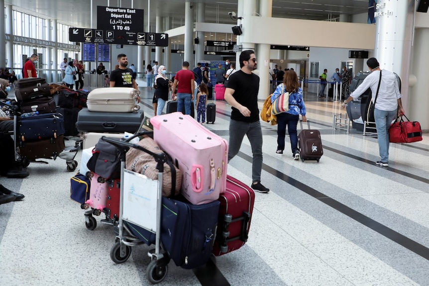  Passengers walk with their luggage at Beirut international airport in Beirut