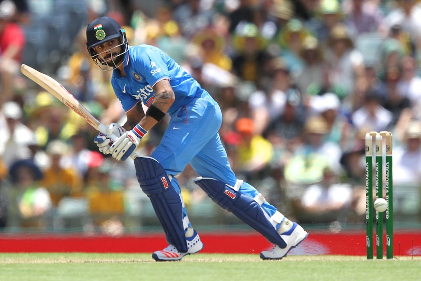 Virat Kohli batting a cricket ball on a pitch at the WACA