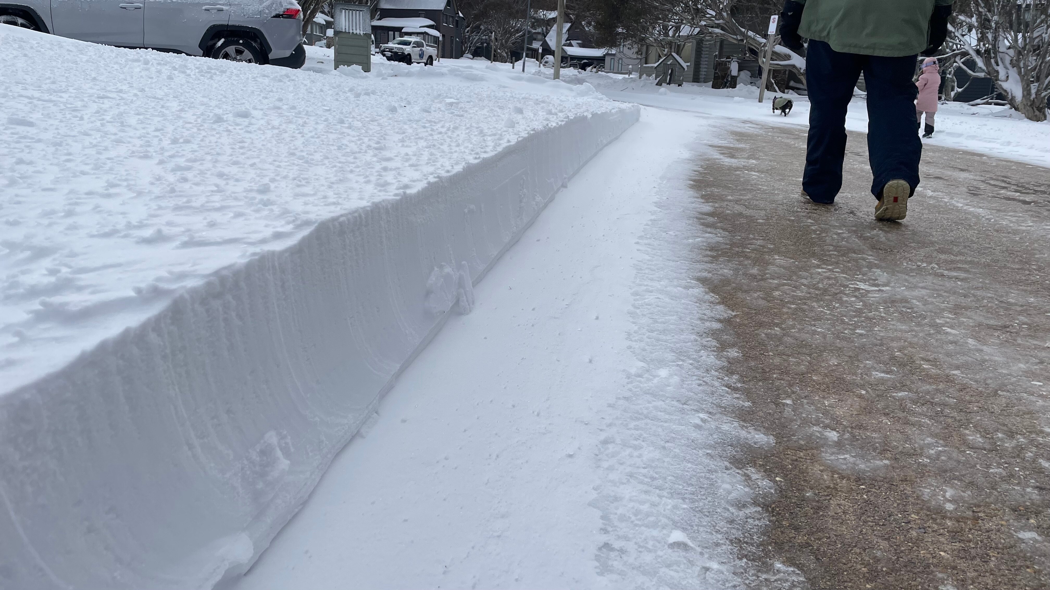 Thick snowfall on side of a road in Dinner Plain, Victoria