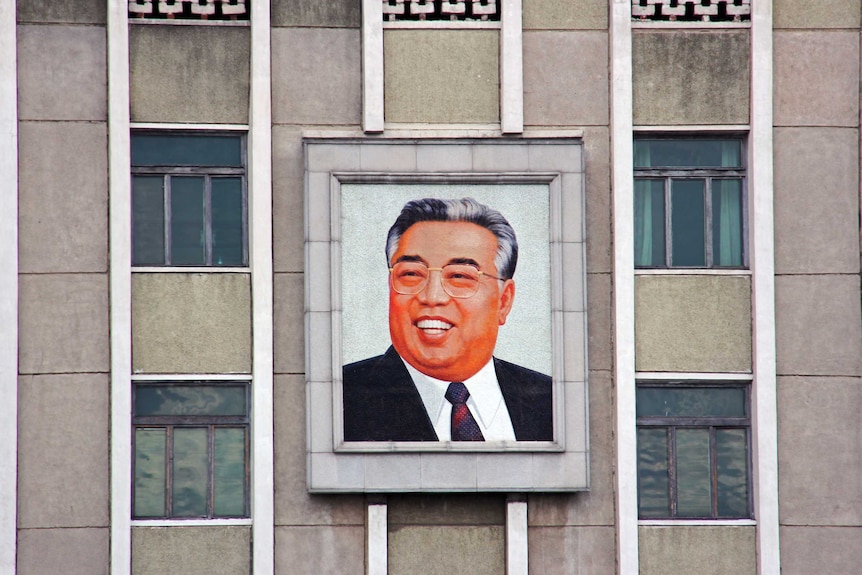 A portrait of Kim Il Sung.