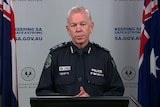 A man with grey hair in police uniform