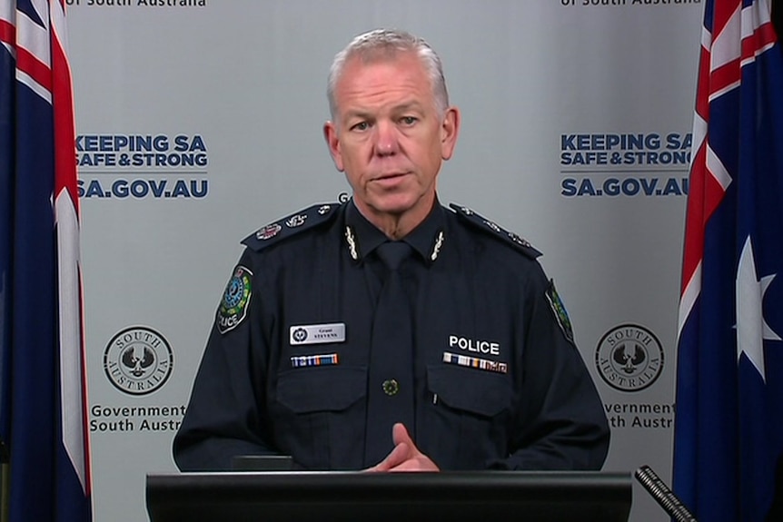 A man with grey hair in police uniform