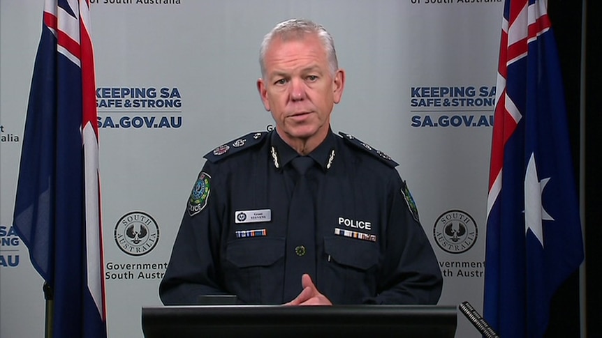 A man with grey hair in police uniform