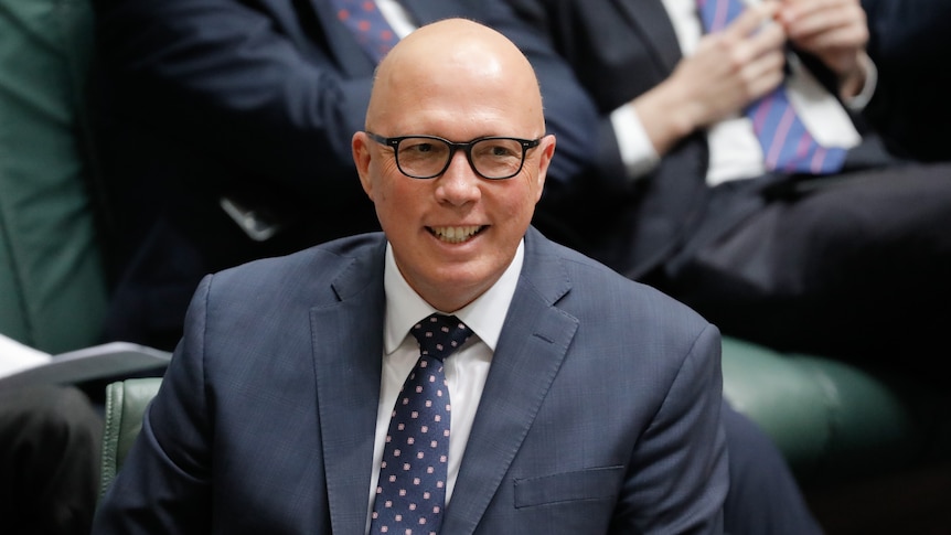 Peter Dutton grins in the House of Representatives. 
