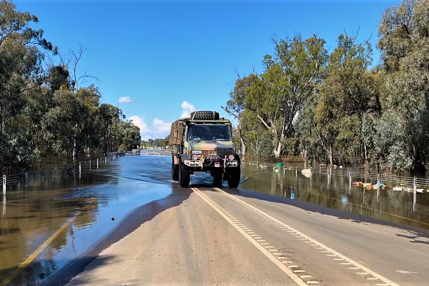 An army vehicle driving through flood water