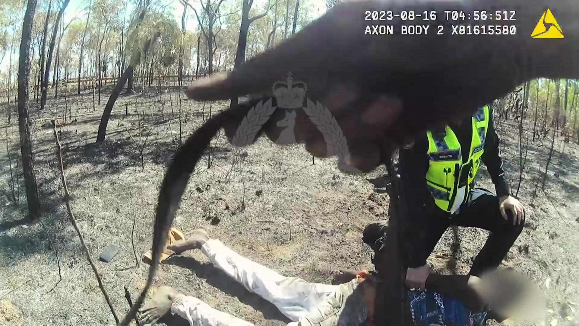 A thumbnail from a video of police arresting an Indigenous teenager in burnt out forest.